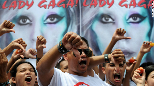 Members of Biblemode Youth Philippines protest in Manila Saturday in front of a banner showing Lady Gaga.