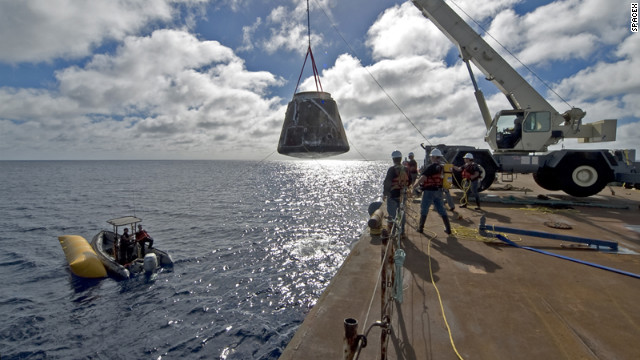 The first Dragon capsule to make it into orbit and return to Earth was launched in December 2010. Here, crews haul the charred capsule out of the ocean.