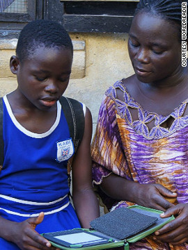 Deborah, a participant in Worldreader's pilot program in Ghana, reads with her mother. Students are encouraged to take home their e-readers to share the benefits of the device with their families.