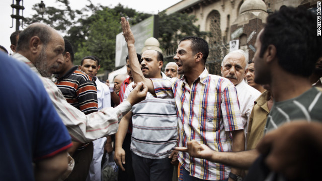 Supporters of various candidates debate outside Al-Fatah Mosque in Cairo.
