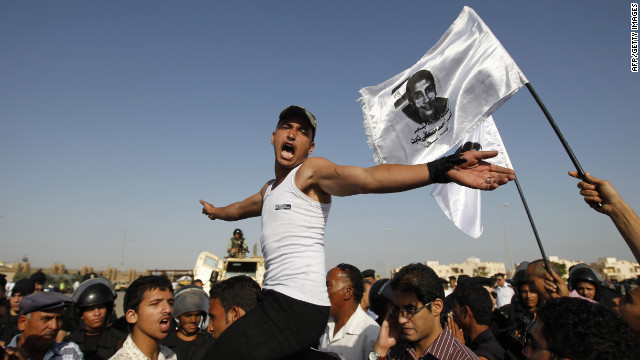 Youths protest against Mubarak in Cairo.