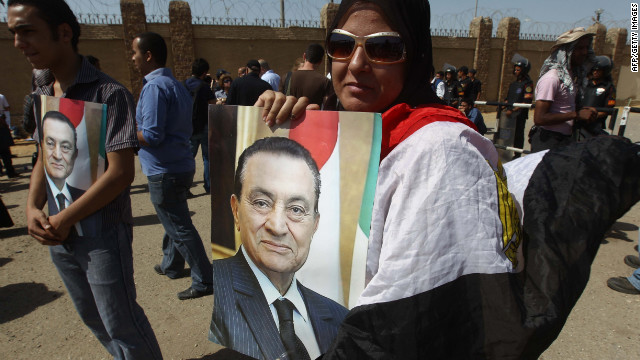 Mubarak supporters also showed up to demonstrate outside of the courthouse, carrying signs and portraits.