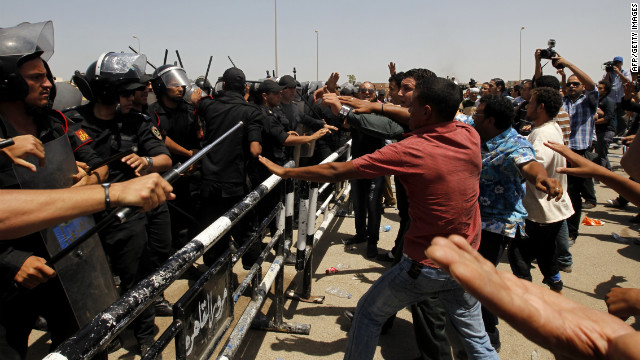 Protesters and policemen clash after the announcement of Mubarak's guilty verdict.