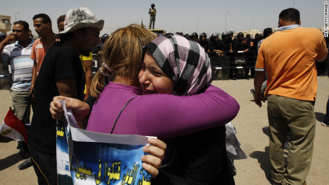 Emotional anti-Mubarak protesters embrace after the verdict against the former president was handed down.