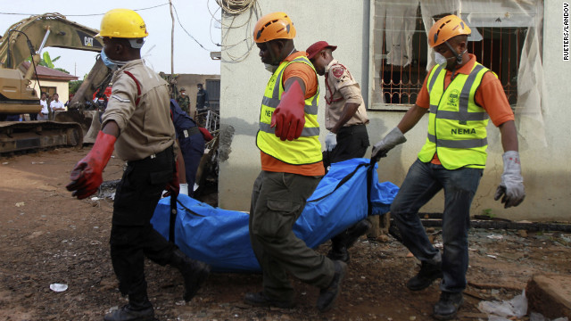 Rescue workers remove a victim of Sunday's plane crash in a Lagos, Nigeria, residential area on Monday, June 4. All 153 people aboard were killed.