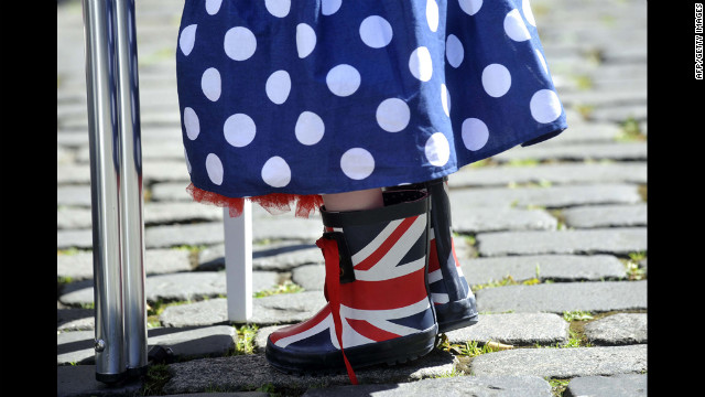 A small girl wears Union Jack boots and a skirt in Britain's colors during a street party.