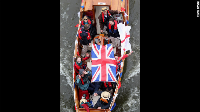 Revellers enjoy the River Pageant on the River Thames.