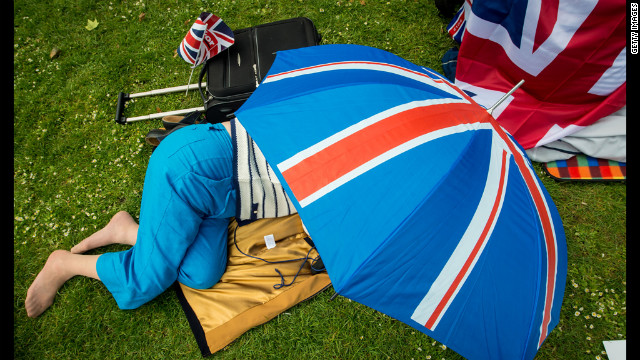 A woman takes refuge under a Union Jack umbrella in St Jame's Park. 