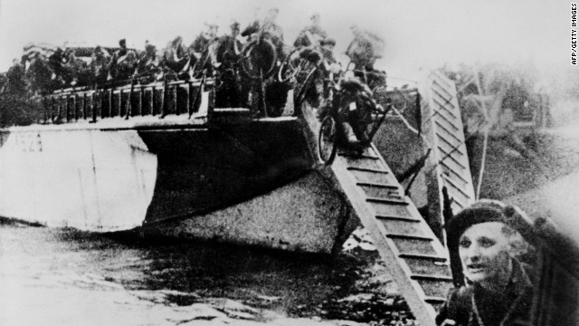 French commandos equipped with bicycles disembark from their landing craft after Allied forces stormed the Normandy beaches. Germans rained mortars and artillery down on Allied troops, killing many before they could even get out of their boats. Fighting was especially fierce at Omaha Beach, where Nazi fighters nearly wiped out the first wave of invading forces and left the survivors struggling for cover.