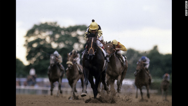 Jockey Jean Cruguet guides Seattle Slew to the Triple Crown at the Belmont Stakes in 1977.