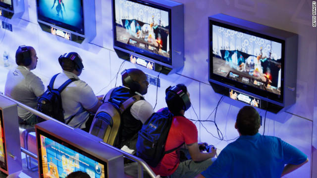 Attendees play new video games at the Sony PlayStation booth this week during the E3 gaming conference.