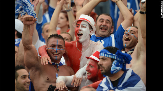 Greek and Polish fans cheer for their teams before the match.