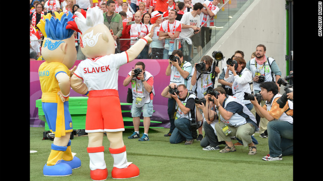 Mascots Slavko, left, and Slavek, right, pose before the match between Poland and Greece.