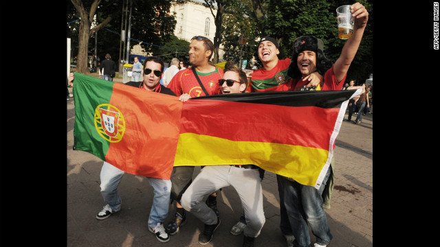 German and Portugese fans show off their nations' flags.