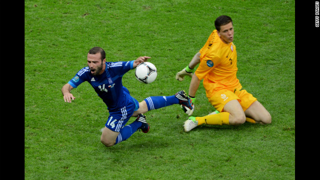 Wojciech Szczesny of Poland fouls Dimitris Salpigidis of Greece for a penalty.