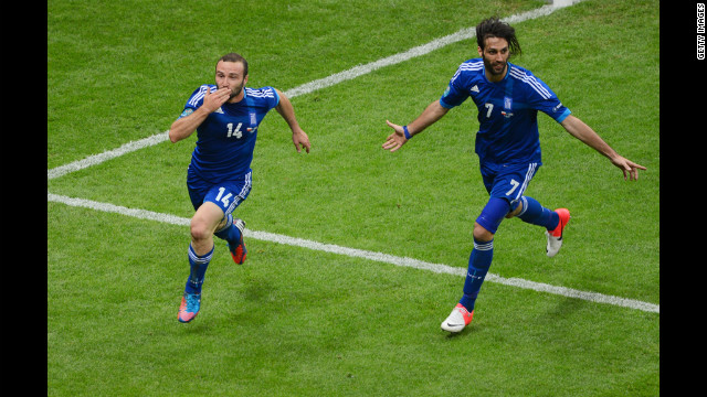 Dimitris Salpigidis and Georgios Samaras of Greece celebrate their first goal against Poland.