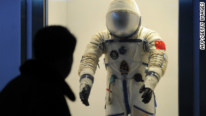 A visitor at the Shanghai Science & Technology Museum looks at a spacesuit used by Chinese astronauts.