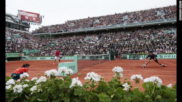 Djokovic and Nadal volley during Sunday's match, which was delayed twice because of rain and finished Monday.