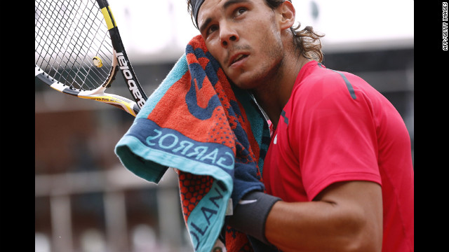 Nadal dries his face during the third set of the match.