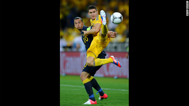 Yevhen Selin of Ukraine and Zlatan Ibrahimovic of Sweden battle for the ball.