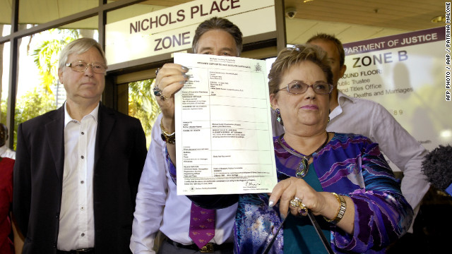 Lindy Chamberlain-Creighton shows reporters Azaria's death certificate outside a Darwin court Tuesday after coroner Elizabeth Morris rules that a dingo caused her baby's death 32 years ago.