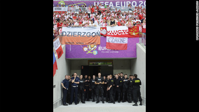Polish police stand at one of the entrances to the pitch before the Group A preliminary round match.