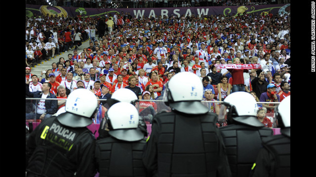 Polish riot police stand guard after the group A match between Poland and Russia.