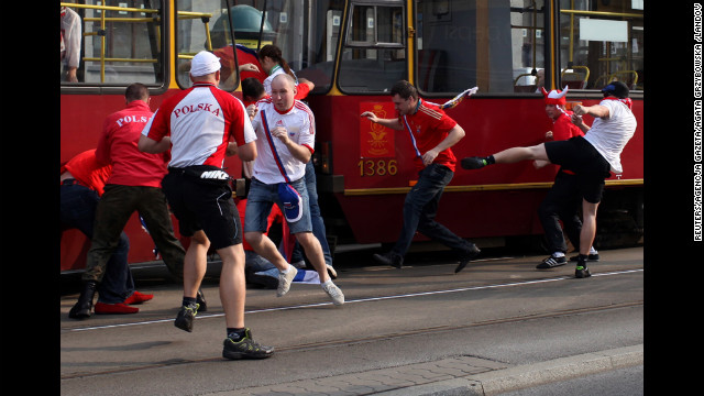 Polish and Russian soccer fans fight before the match between Russia and Poland.