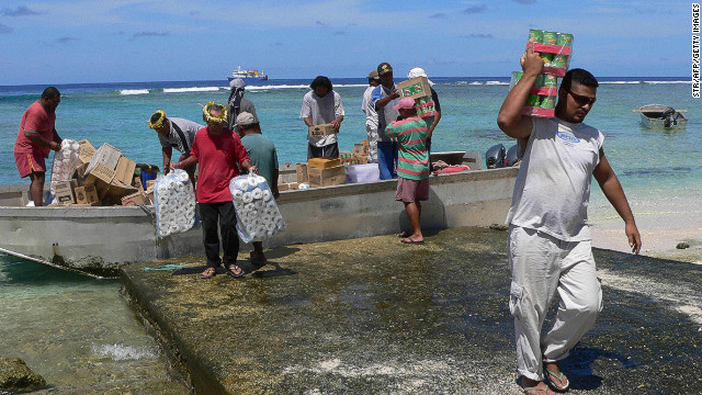 Residents unload goods from a barge in Nukunonu atoll, Tokelau, which has no airport or port.