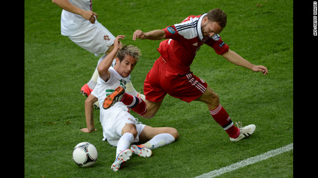 Dennis Rommedahl of Denmark fights for possession with Fabio Coentrao of Portugal.