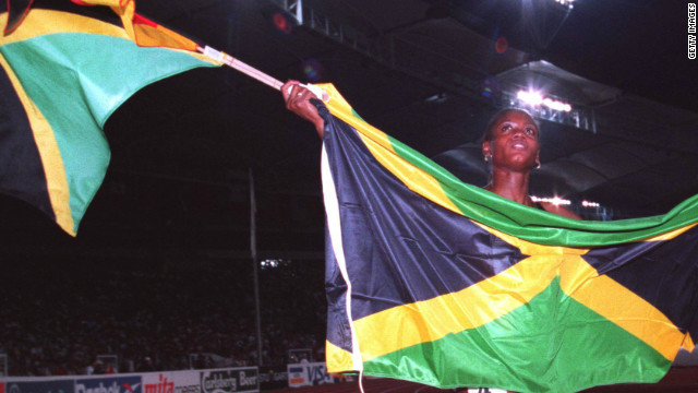 Merlene Ottey shows off the Jamaican flag after her gold medal success at the 1993 World Championships in Stuttgart.