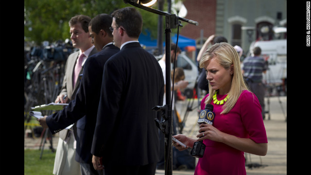 Reporters wait with microphones outside of the Sandusky trial. 