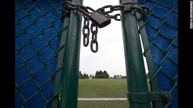 The gate to the practice football field is locked at the Mildred and Louis Lasch Football Building at Penn State University in State College, Pennsylvania