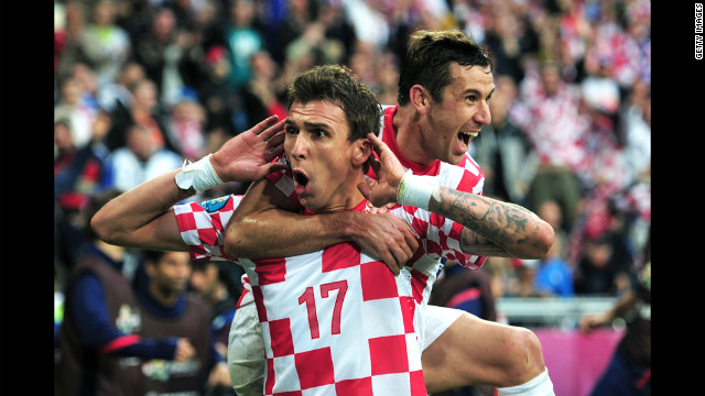 Croatia's Mario Mandzukic and his teammate Darijo Sma celebrate the team's game-tying goal against Italy in Poznan, Poland, on Thursday, June 14. 