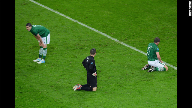 Sean St Ledger, Shay Given and Richard Dunne of Republic of Ireland sit dejected after Fernando Torres of Spain scored Spain's third goal during the Spain-Ireland match.