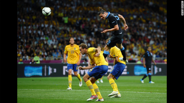Andy Carroll of England heads the first goal during the match between Sweden and England.