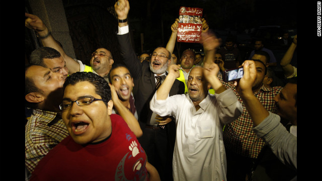 Morsi supporters celebrate Monday in Cairo. Votes in the Egyptian capital, the largest population center, continued to be tallied, but unofficial results by a state-run news website showed Morsi leading elsewhere with 11.2 million votes, compared with 10.3 million for Ahmed Shafik, the last prime minister in the waning days of Mubarak's regime.