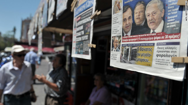 People read newspapers which detail the coalition talks on June 19. Greece hasn't had an elected government for 223 days.