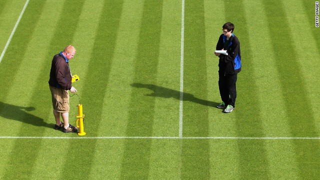 Wimbledon ground staff conduct a test to determine how the ball is bouncing on a court. 