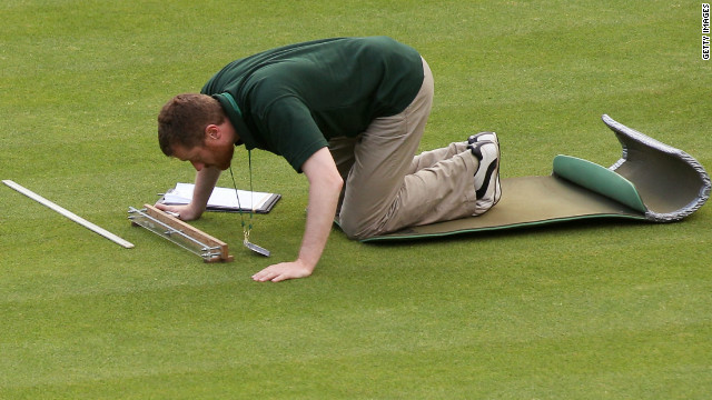 A member of the Wimbledon ground staff monitors one of the test areas on Centre Court.