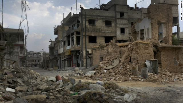 Damage and destruction litter a street in the battered city of Qusayr, southwest of Homs, in western Syria, on Wednesday.