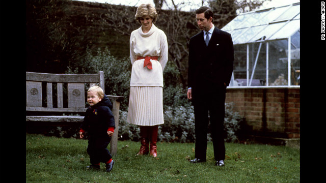 Prince William takes his first steps in public with his parents in the walled garden at Kensington Palace on December 14, 1983.