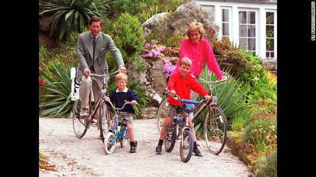 Prince William and Prince Harry ride bicycles with their parents in 1989 while on holiday in the Scilly Isles.