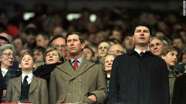 Prince Charles and Prince Harry, at left, stand for anthems as Prince William, right, looks around during the Wales-Scotland game in the 1996 Five Nations rugby championship.