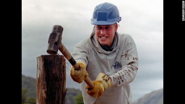 Prince William hammers a log while helping construct walkways in a remote village in Chile during his Raleigh International expedition in 2000.