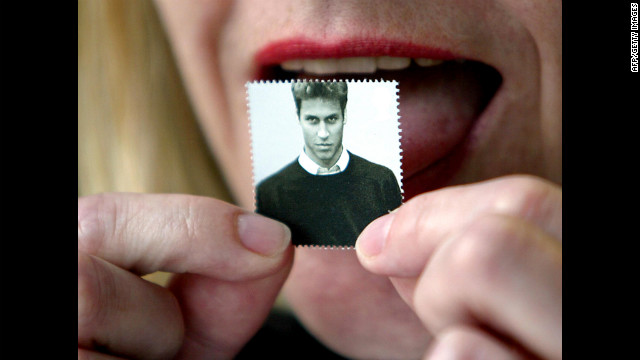 A London officeworker licks a first-class stamp that was issued to mark Prince William's 21st birthday in 2003. Commemorative coins were also minted for the occassion.