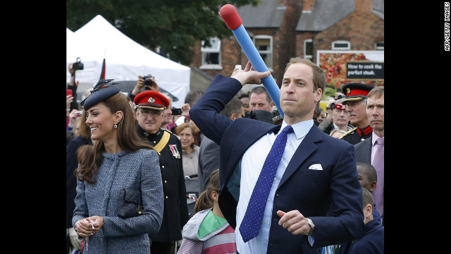 Prince William throws a foam javelin as the Duchess of Cambridge stands at his side during a visit to Nottingham, England, on June 13, 2012. The couple were in the city as part of Queen Elizabeth II's diamond jubilee tour, marking the 60th anniversary of her accession to the throne.