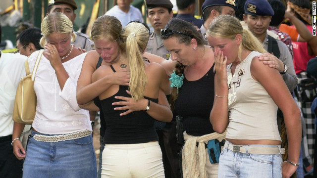 Several Australian women hug each other as they visit the blast site in the tourist area of Kuta, near Denpasar, on October 17, 2002. 