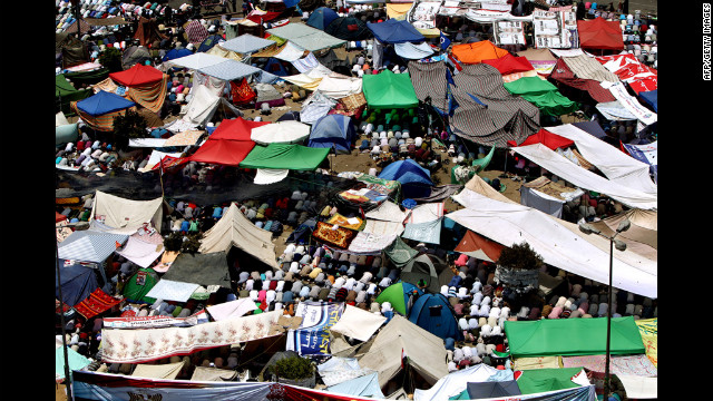 Protesters perform Friday noon prayer under tents erected in Cairo's landmark Tahrir Square.