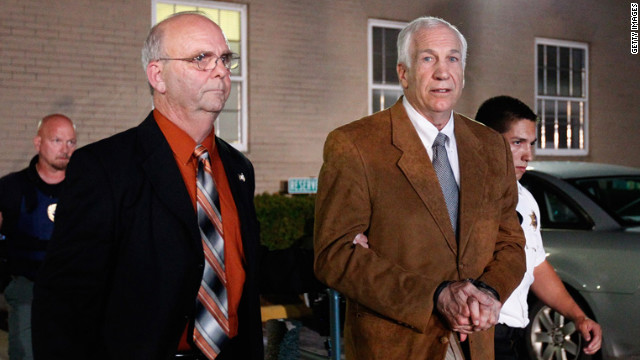 Sandusky faces the cameras as he is led to a sheriff's vehicle in handcuffs after the reading of the verdict.